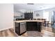 Contemporary kitchen island with granite countertops, stainless steel dishwasher, and modern cabinetry at 5251 Wildwood Way, Davenport, FL 33837