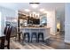 Eat-in kitchen featuring a center island with seating, dark cabinets, and stainless steel appliances at 5251 Wildwood Way, Davenport, FL 33837