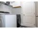 Efficient laundry room with modern appliances and ample storage; cabinets, shelving, and machines at 5251 Wildwood Way, Davenport, FL 33837