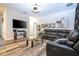 Comfortable living room featuring a large leather sectional sofa and a modern glass coffee table at 5251 Wildwood Way, Davenport, FL 33837