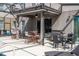 Covered patio with ceiling fan, grill, and table and chairs for backyard entertaining and relaxation at 5251 Wildwood Way, Davenport, FL 33837