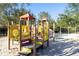 Playground with slides, climbing features, and swings in a sand area at 5251 Wildwood Way, Davenport, FL 33837