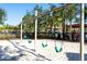 Swings at the community playground in a sand area at 5251 Wildwood Way, Davenport, FL 33837