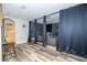 Home theater under construction with hardwood floors, black dividing curtains and speakers at 5251 Wildwood Way, Davenport, FL 33837