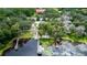 Aerial view of a lakefront property with a dock, boat house, and lush greenery at 5584 N Dean Rd, Orlando, FL 32817