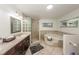 Beautiful bathroom with double vanity, tub, and walk-in glass block shower at 5584 N Dean Rd, Orlando, FL 32817