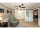 A bedroom has a large closet, neutral paint colors and an accent chair next to a nightstand at 5584 N Dean Rd, Orlando, FL 32817