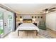 The primary bedroom has light hardwood floors and a large bed with nightstands and lamps at 5584 N Dean Rd, Orlando, FL 32817