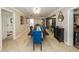 Formal dining room with large table, blue chairs, and decorative accents, adjacent to the kitchen at 5584 N Dean Rd, Orlando, FL 32817