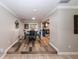 Dining room area with step-up, wood-look flooring and a view of the open kitchen at 5584 N Dean Rd, Orlando, FL 32817