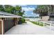 Garage exterior featuring a paved driveway leading to a lake with serene water views at 5584 N Dean Rd, Orlando, FL 32817