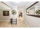 Hallway with tile flooring, decorative mirror and wall art, leading to living areas at 5584 N Dean Rd, Orlando, FL 32817