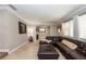 Cozy living room featuring a leather sectional, neutral walls, and plush carpeting at 5584 N Dean Rd, Orlando, FL 32817