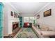 Comfortable living room features a brick fireplace, stylish furnishings, and a large window at 5584 N Dean Rd, Orlando, FL 32817
