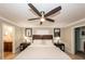 Inviting bedroom with a ceiling fan, stylish decor, and access to an ensuite bathroom at 5584 N Dean Rd, Orlando, FL 32817