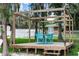 Outdoor deck area with a dining table and blue chairs under a wooden pergola at 5584 N Dean Rd, Orlando, FL 32817