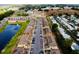 Aerial view of a community featuring townhomes and a serene pond at 601 Washington Palm Loop, Davenport, FL 33897