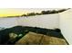 Fenced backyard at sunset with dark pavers and some plants at 601 Washington Palm Loop, Davenport, FL 33897
