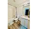 Bathroom with vinyl floor, shower-tub combo, and single sink vanity at 601 Washington Palm Loop, Davenport, FL 33897