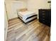 A well lit bedroom with modern flooring, and a padded headboard at 601 Washington Palm Loop, Davenport, FL 33897