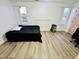 The bedroom features wood flooring, a large window, and a neutral paint palette at 601 Washington Palm Loop, Davenport, FL 33897