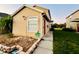 A tan house with white trim and neatly landscaped yard at 601 Washington Palm Loop, Davenport, FL 33897