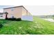 Home with a white fence backing up to a pond at 601 Washington Palm Loop, Davenport, FL 33897