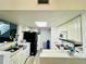 Kitchen with white cabinets, black refrigerator, and white appliances at 601 Washington Palm Loop, Davenport, FL 33897