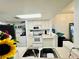 Bright kitchen with white cabinetry and a view of the laundry room at 601 Washington Palm Loop, Davenport, FL 33897