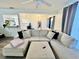 Open concept living room featuring a large sectional sofa and bar top to kitchen at 601 Washington Palm Loop, Davenport, FL 33897