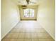 Empty living room with light colored tiles and air conditioner at 601 Washington Palm Loop, Davenport, FL 33897