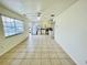 Open living space with tile flooring, ceiling fan, and white kitchen cabinets at 601 Washington Palm Loop, Davenport, FL 33897