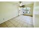 Empty living room with light colored tiles and air conditioner at 601 Washington Palm Loop, Davenport, FL 33897