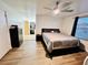 Comfortable main bedroom with wood-look floors, neutral decor, and a queen-size bed at 601 Washington Palm Loop, Davenport, FL 33897