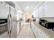 Long, well-lit kitchen with white cabinetry, stainless steel appliances, and granite countertops at 7108 Sheffield Dr, Lakeland, FL 33810