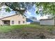 Backyard view features a home, lawn, and storage shed at 7440 Windsome Ct, Orlando, FL 32810