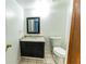 Bathroom vanity with granite countertops and a framed mirror at 7440 Windsome Ct, Orlando, FL 32810