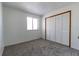 Bedroom with plush gray carpet and a spacious closet at 7440 Windsome Ct, Orlando, FL 32810