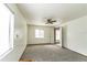 Spacious bedroom features soft carpet and a ceiling fan at 7440 Windsome Ct, Orlando, FL 32810