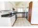 Clean kitchen featuring white cabinets, granite countertops, stainless steel appliances, and a pantry at 7440 Windsome Ct, Orlando, FL 32810