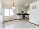 Bright eat-in kitchen boasting white cabinets, stainless steel appliances, and tile flooring at 7440 Windsome Ct, Orlando, FL 32810