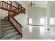 Open living room features a staircase, vaulted ceilings, neutral walls, and tile flooring throughout at 7440 Windsome Ct, Orlando, FL 32810