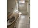 Bathroom with tiled floor and shower/tub combo and a single sink at 7741 Bardmoor Hill Cir, Orlando, FL 32835