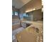 Bathroom featuring double sinks, large mirrors, and a separate tub and shower at 7741 Bardmoor Hill Cir, Orlando, FL 32835