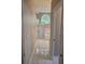 Hallway view of bathroom showcasing a large shower and garden tub with an arched window at 7741 Bardmoor Hill Cir, Orlando, FL 32835