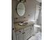 Bathroom with tiled countertop, white cabinets, oval mirror, and tiled shower/tub at 7741 Bardmoor Hill Cir, Orlando, FL 32835