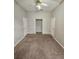 Spacious bedroom with a ceiling fan, neutral walls, carpet, and ample closet space at 7741 Bardmoor Hill Cir, Orlando, FL 32835