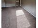 Bedroom with neutral walls and carpet, features a built-in closet with shelves for storage at 7741 Bardmoor Hill Cir, Orlando, FL 32835