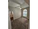 Bright, carpeted bedroom with a ceiling fan and a large arched window at 7741 Bardmoor Hill Cir, Orlando, FL 32835