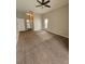 Spacious carpeted bedroom features a ceiling fan and natural light from a window at 7741 Bardmoor Hill Cir, Orlando, FL 32835
